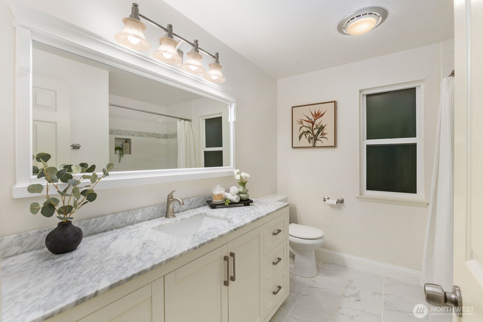 18505 Northeast 26th Street Redmond, WA 98052 - Photo 23 of 38 a bathroom with a granite countertop sink a toilet and a mirror