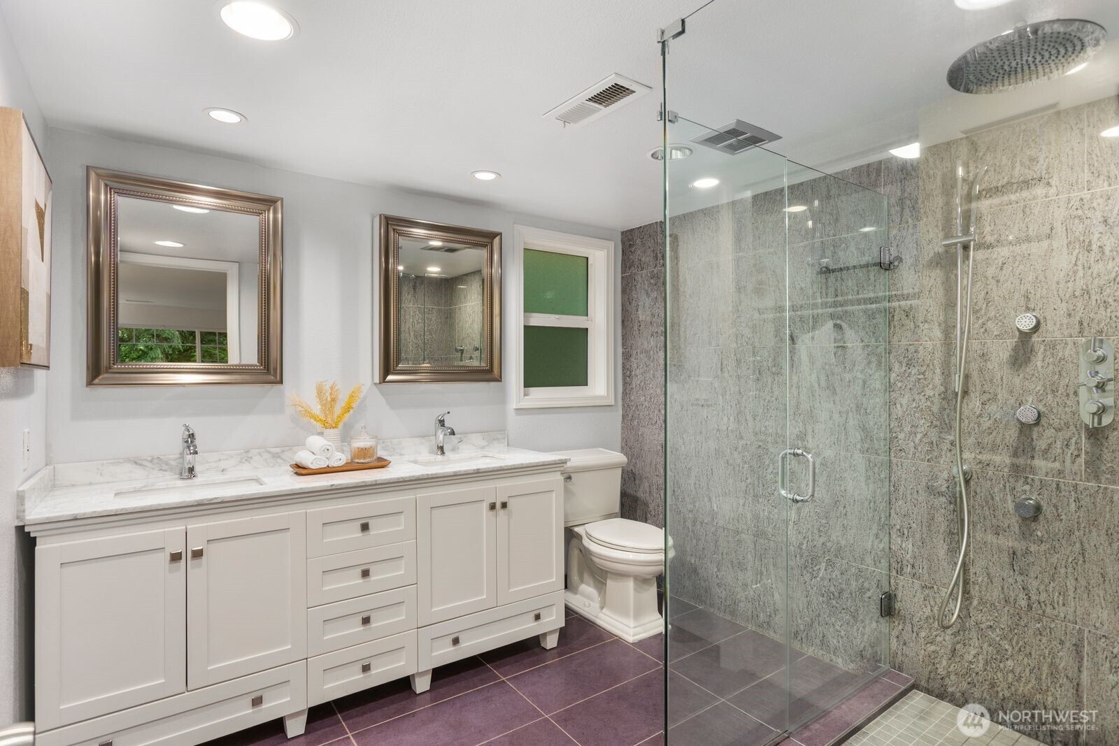 18505 Northeast 26th Street Redmond, WA 98052 - Photo 26 of 38 a bathroom with a double vanity sink a toilet and shower