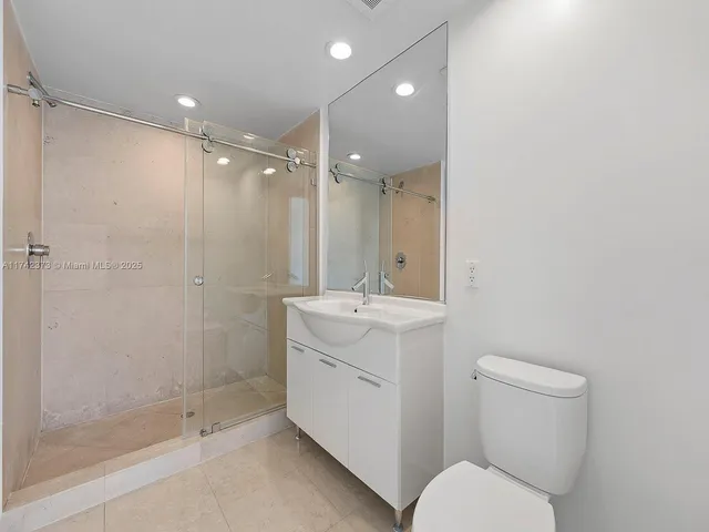 a bathroom with a toilet sink and shower