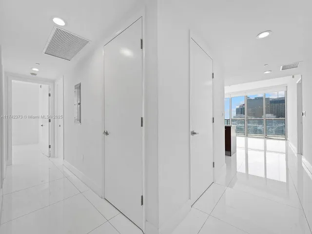 a bathroom with a glass shower door and a shower