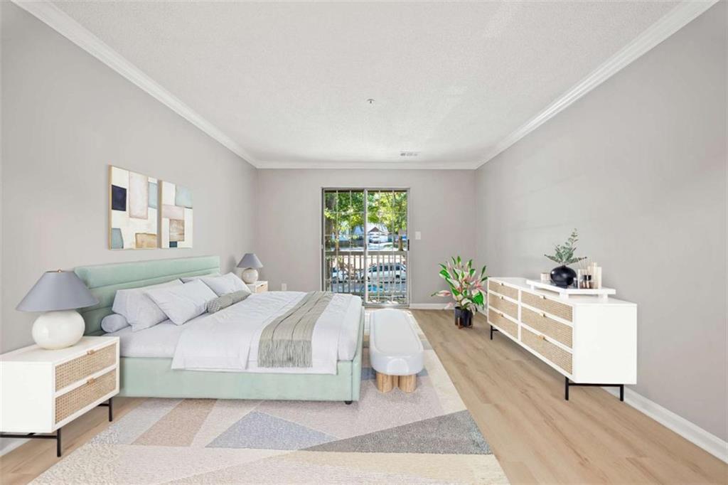 211 Cobblestone Trail Avondale Estates, GA 30002 - Photo 11 of 19 a spacious bedroom with a large bed and a window