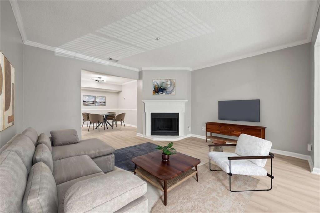 211 Cobblestone Trail Avondale Estates, GA 30002 - Photo 3 of 19 a living room with furniture a rug and a fireplace
