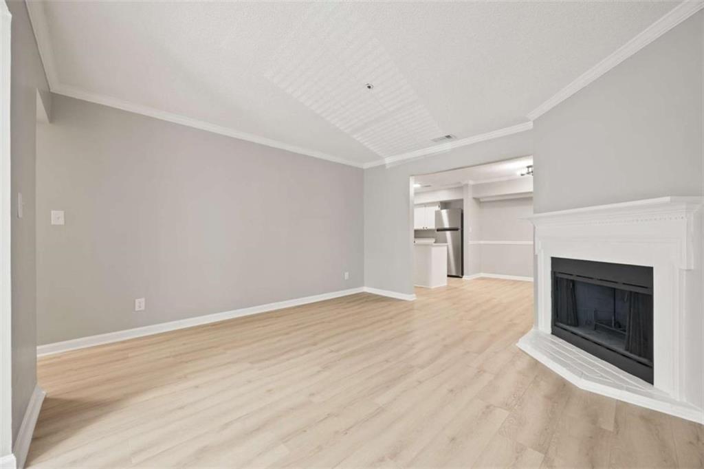 211 Cobblestone Trail Avondale Estates, GA 30002 - Photo 7 of 19 a view of empty room with wooden floor and fireplace