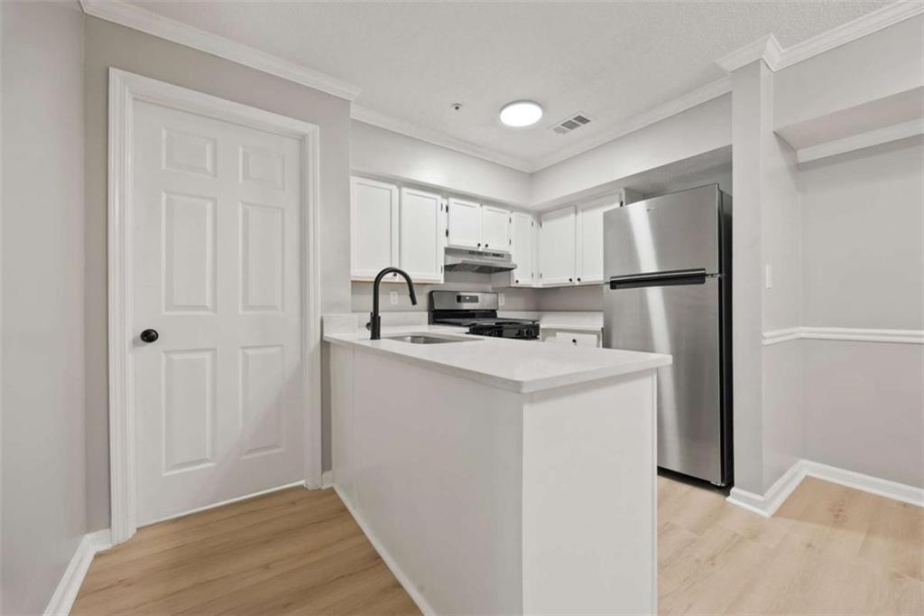 211 Cobblestone Trail Avondale Estates, GA 30002 - Photo 9 of 19 a kitchen with a refrigerator sink and cabinets