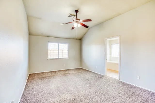 a view of empty room with ceiling fan