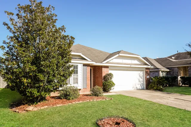 a front view of a house with a garden and plants