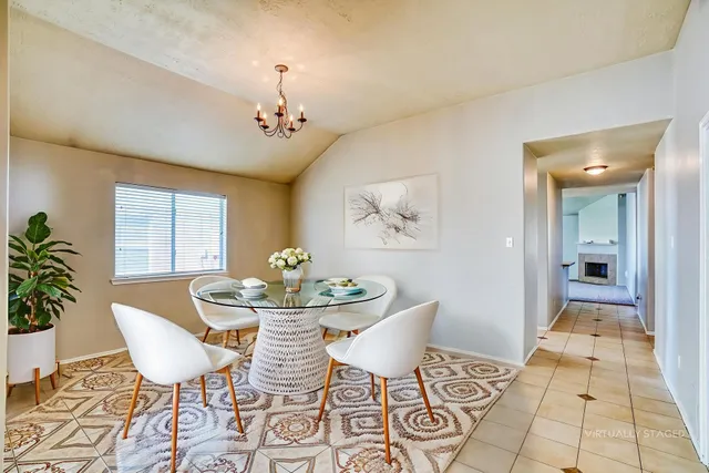 a dining room with furniture a rug and wooden floor