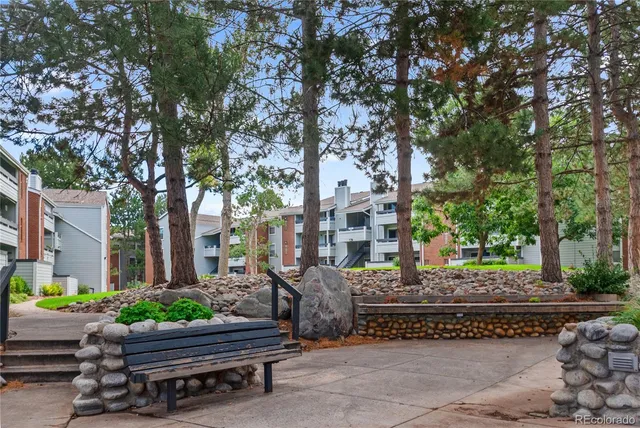 a wooden bench sitting in front of a building