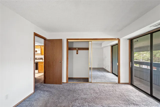 an empty room with windows and closet