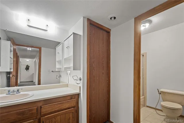 a spacious bathroom with a granite countertop sink mirror and toilet