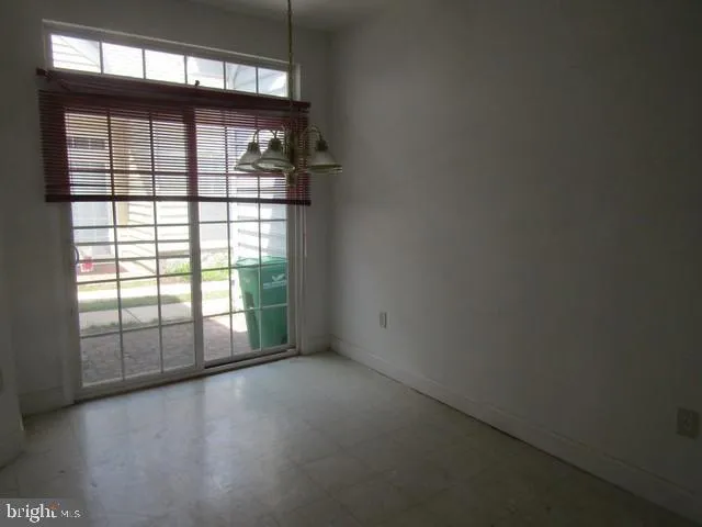a kitchen with granite countertop a sink stove and cabinets