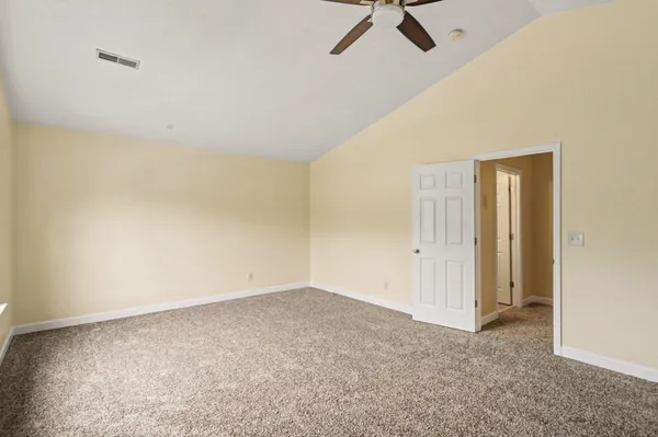 a view of a room with a ceiling fan