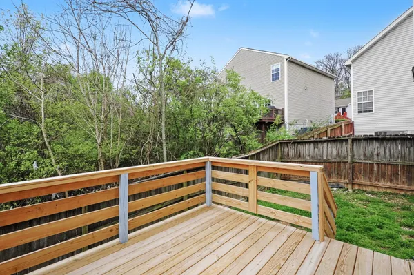 a view of outdoor space with deck and trees
