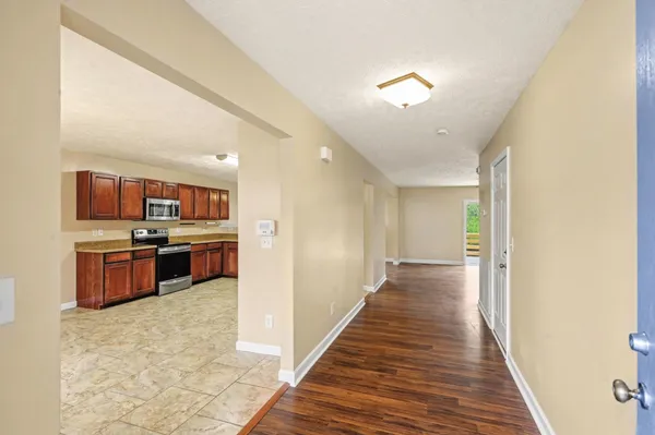 a view of a hallway with a kitchen