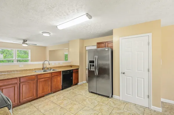 a kitchen with stainless steel appliances granite countertop a refrigerator and a sink