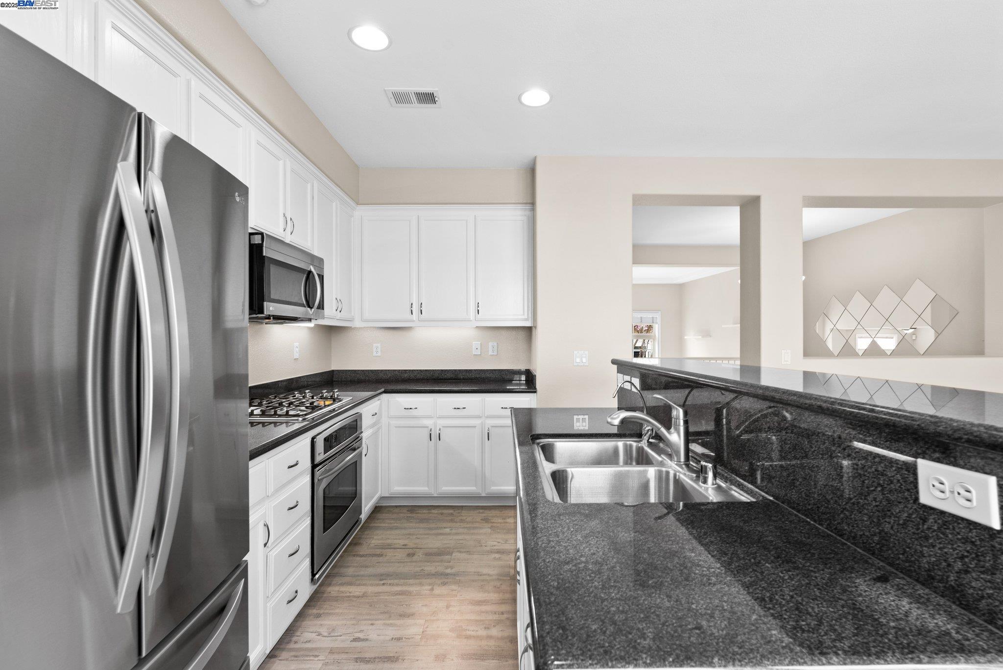 3658 Whitworth Drive Dublin, CA 94568 - Photo 14 of 36 a kitchen with stainless steel appliances granite countertop a sink stove and refrigerator