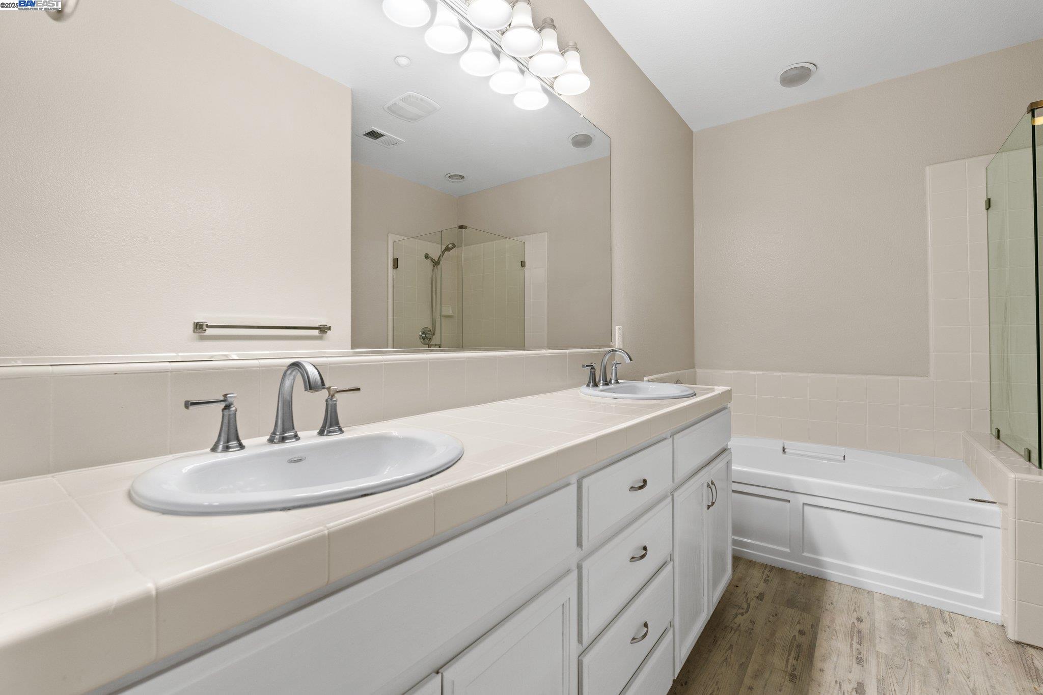 3658 Whitworth Drive Dublin, CA 94568 - Photo 20 of 36 a bathroom with a double vanity sink a toilet and a mirror