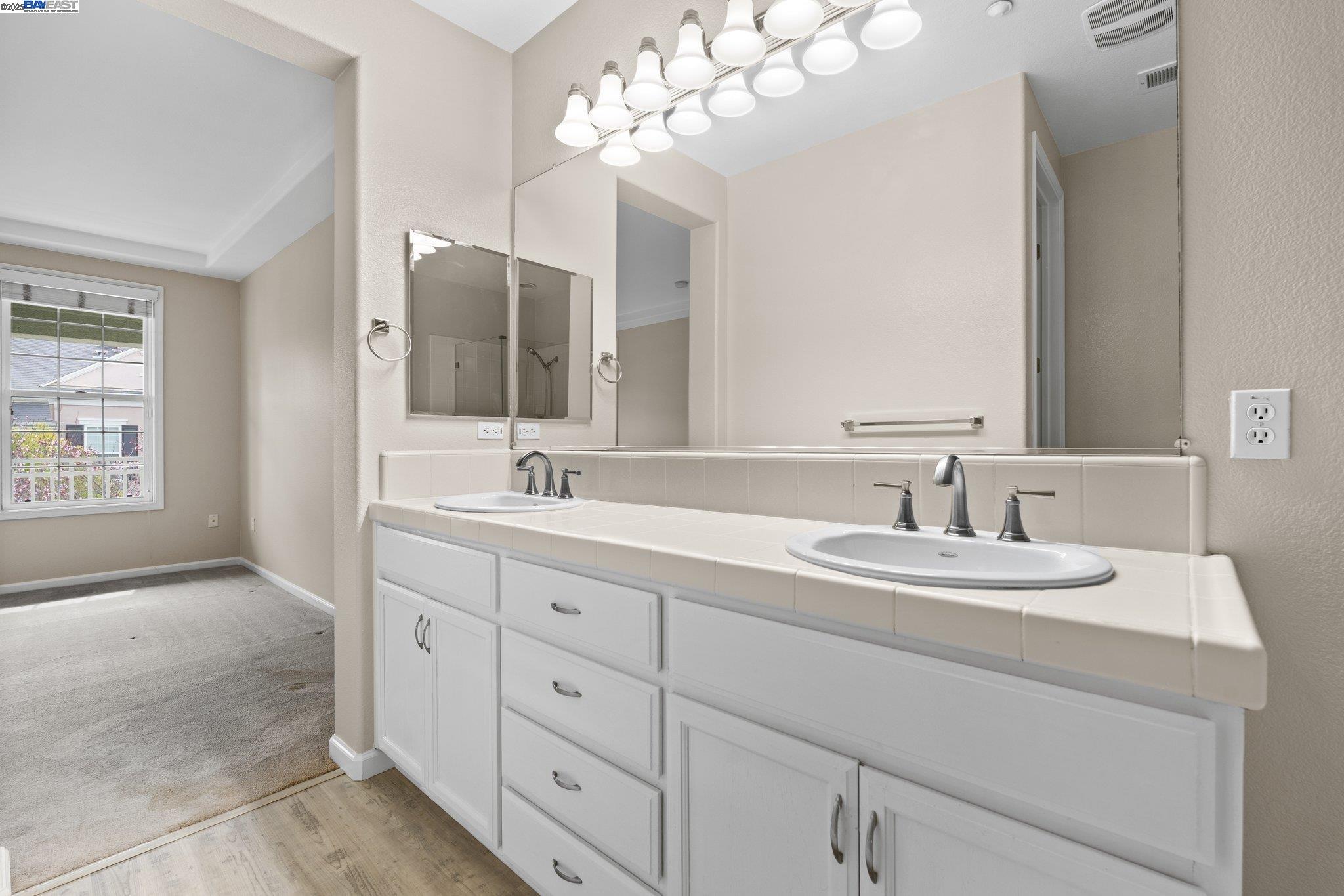 3658 Whitworth Drive Dublin, CA 94568 - Photo 29 of 36 a bathroom with double sink and a mirror