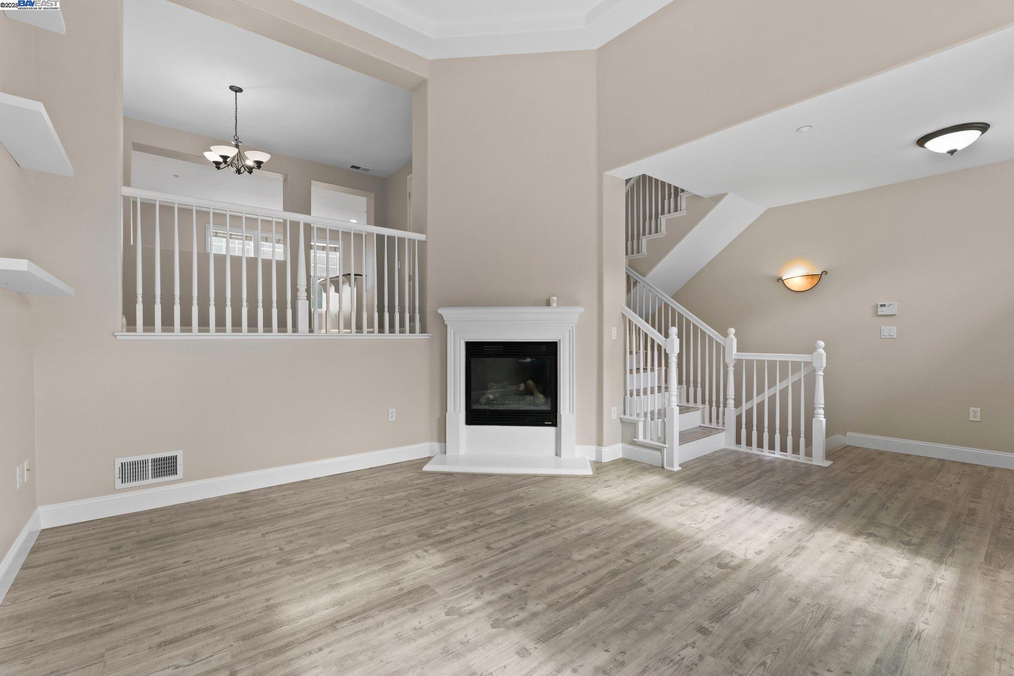 3658 Whitworth Drive Dublin, CA 94568 - Photo 5 of 36 an empty room with wooden floor staircase and windows