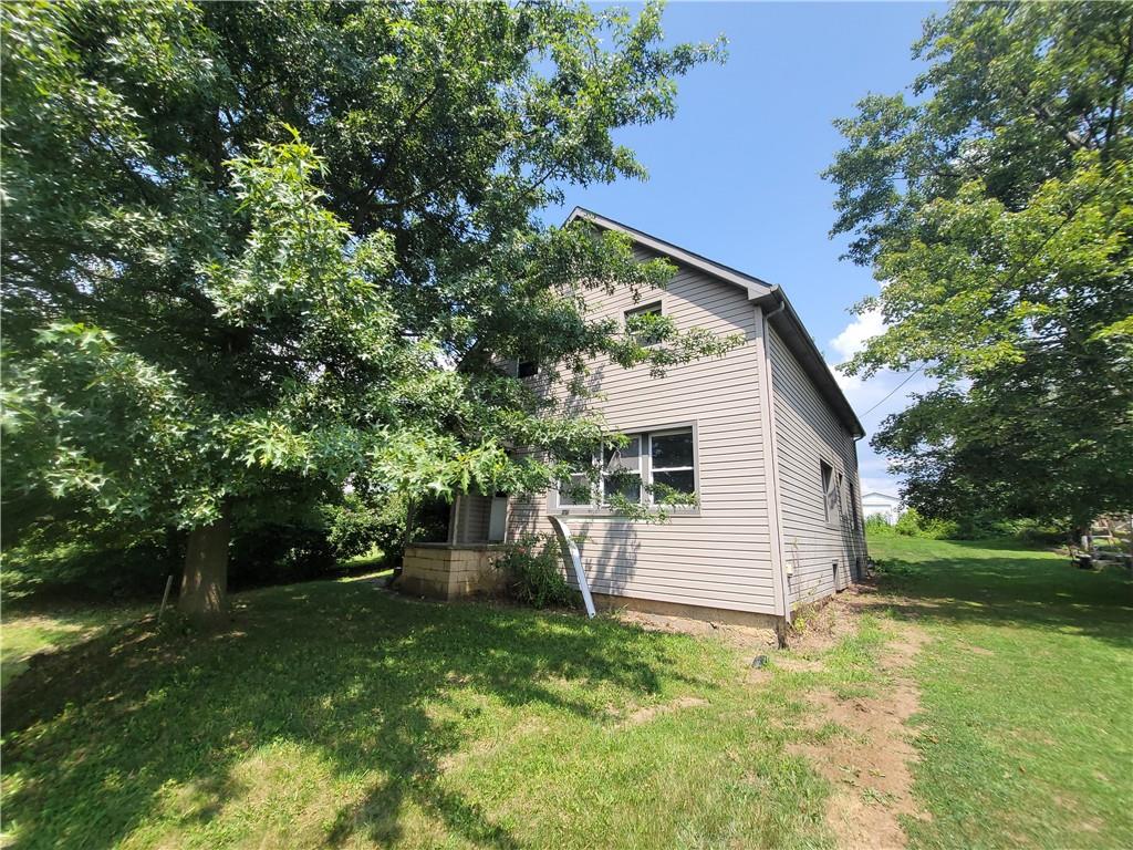 a backyard of a house with plants and tree