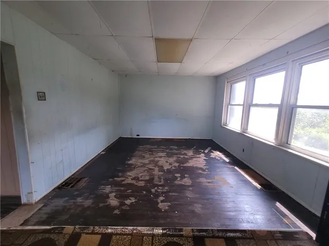 an empty room with wooden floor