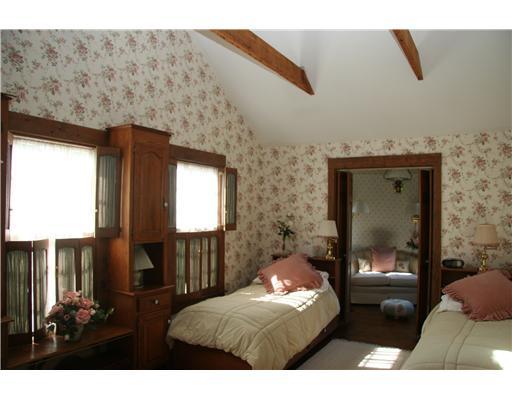603 Steamboat Road, Unit 4 Greenwich, CT 06830 - Photo 14 of 14 a bedroom with a bed and wooden floor