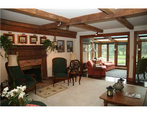 603 Steamboat Road, Unit 4 Greenwich, CT 06830 - Photo 5 of 14 a living room with furniture a fireplace and a flat screen tv