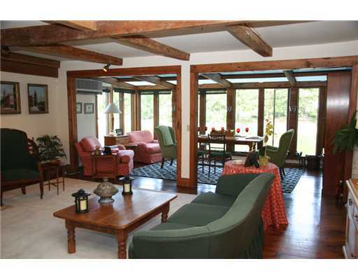 603 Steamboat Road, Unit 4 Greenwich, CT 06830 - Photo 8 of 14 a living room with furniture a floor to ceiling window and potted plants