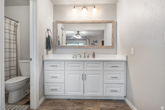 41 Benchmark Village Tooele, UT 84074 - Photo 12 of 26 Bathroom featuring vanity, a shower with curtain, wood finish floors, and ceiling fan