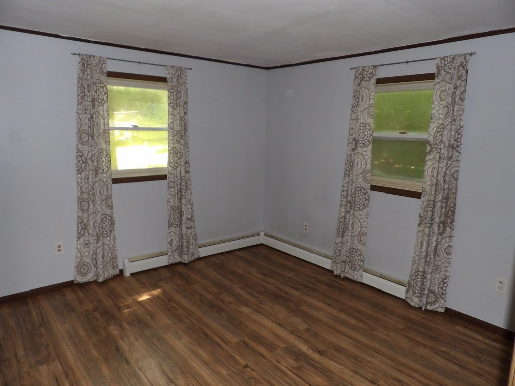 19 Kimball Road Amesbury, MA 01913 - Photo 17 of 26 an empty room with wooden floor and a window