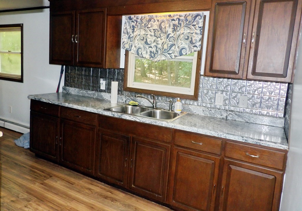 19 Kimball Road Amesbury, MA 01913 - Photo 9 of 26 a kitchen with granite countertop wooden cabinets a sink and a window