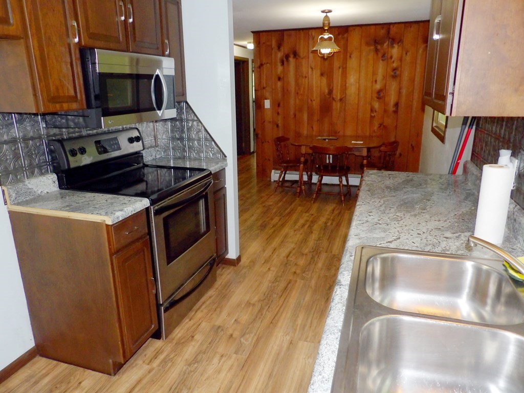 19 Kimball Road Amesbury, MA 01913 - Photo 10 of 26 a kitchen with stainless steel appliances granite countertop a sink stove and cabinets