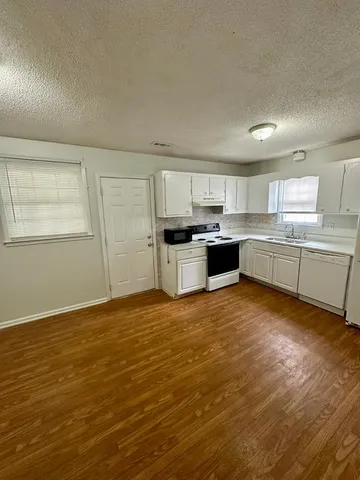 a kitchen with stainless steel appliances granite countertop a sink and cabinets
