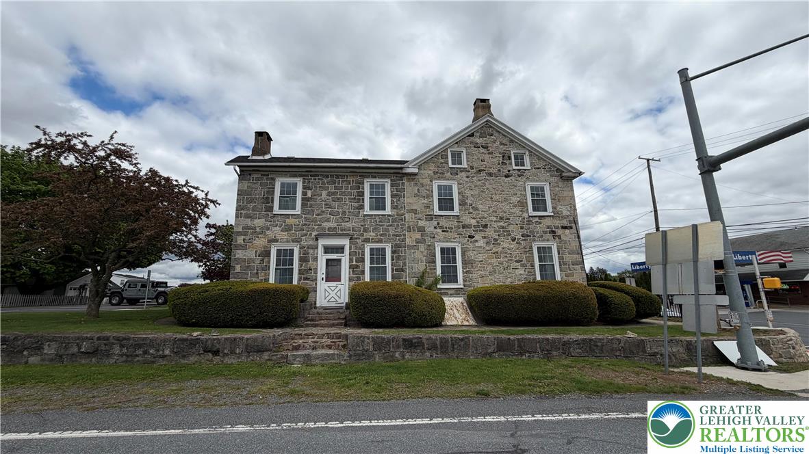 797 Main Street Tatamy, PA 18085 - Photo 2 of 41 a front view of a house with a yard and garage