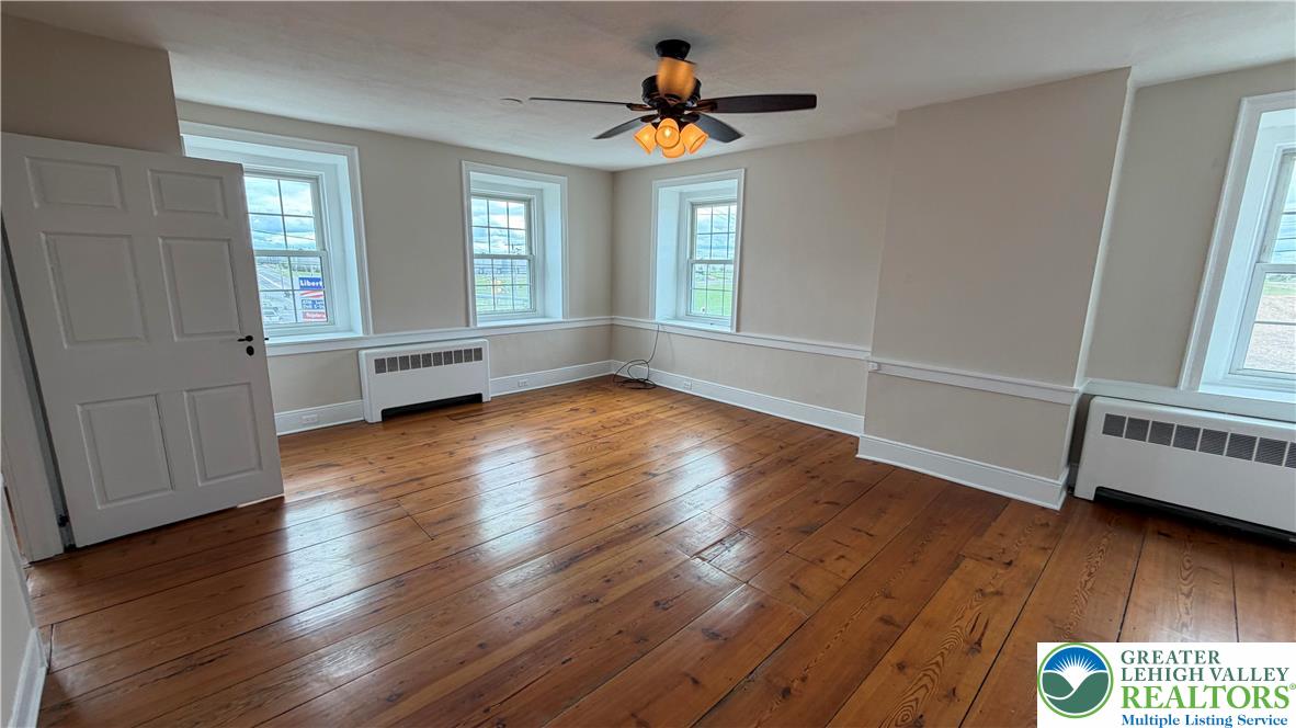 797 Main Street Tatamy, PA 18085 - Photo 24 of 41 an empty room with wooden floor and windows
