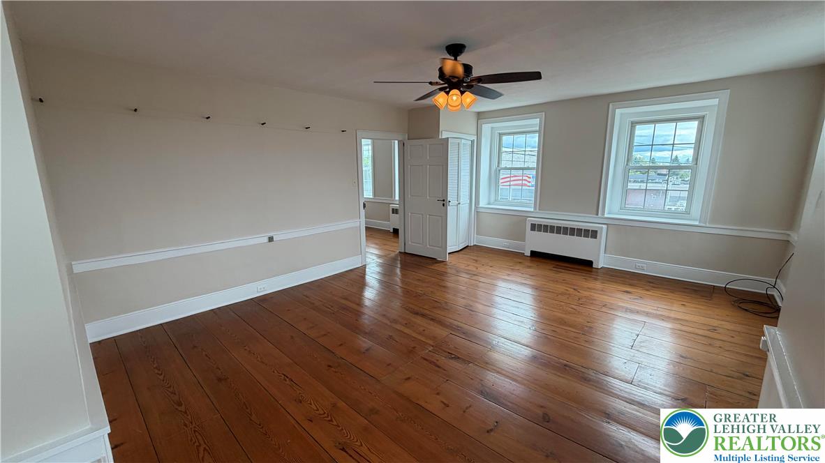 797 Main Street Tatamy, PA 18085 - Photo 25 of 41 an empty room with wooden floor and windows