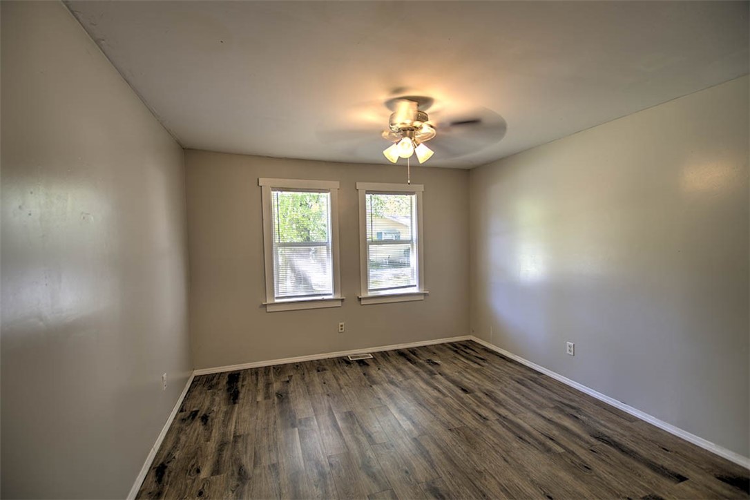 7450 West William Street Decatur, IL 62522 - Photo 7 of 18 wooden floor in an empty room with a window