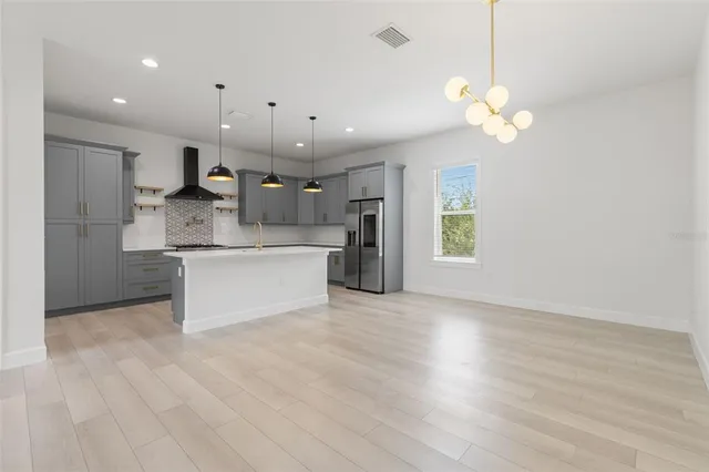 a view of a kitchen with a sink stainless steel appliances and cabinets