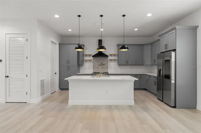 a kitchen with granite countertop a stove sink and cabinets