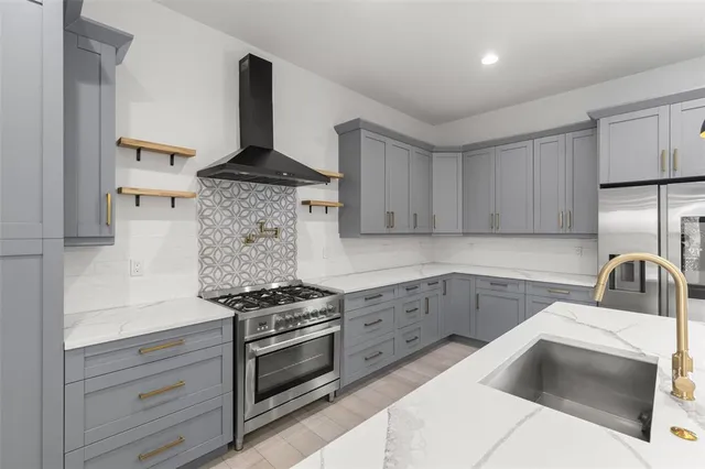 a kitchen with granite countertop a sink stainless steel appliances and counter space