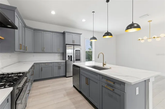 a kitchen with a sink stove and refrigerator
