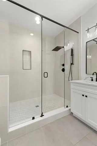 a walk in closet with wooden floor