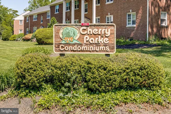 a sign broad in front of a brick building