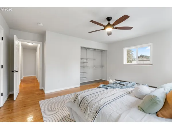 a bedroom with a bed and painting on the wall