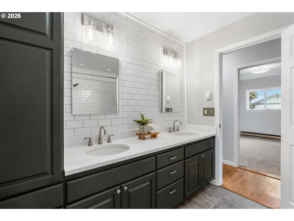 a bathroom with a sink a shower and a mirror