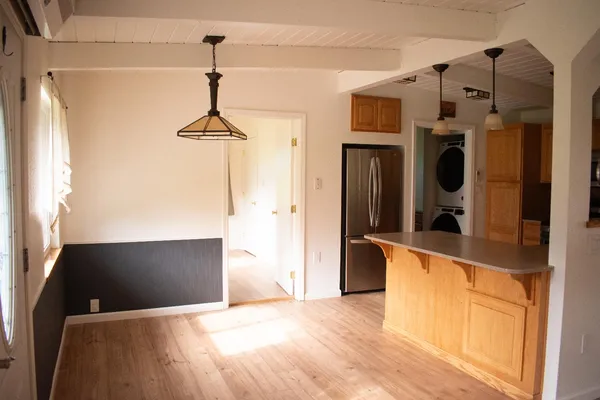 a view of kitchen with furniture and a chandelier