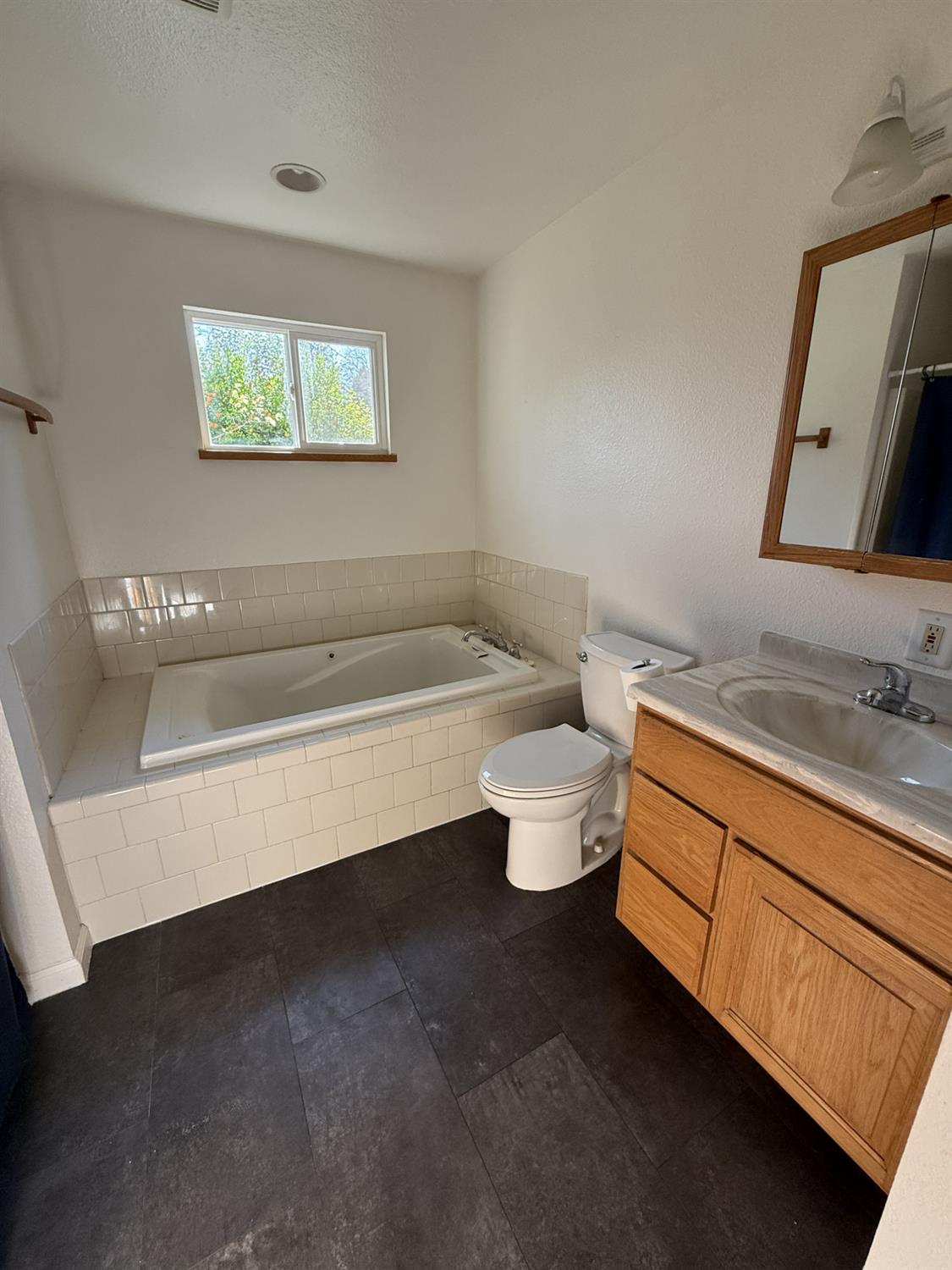 4881 Marshall Road Garden Valley, CA 95633 - Photo 13 of 25 a spacious bathroom with a granite countertop toilet and a sink