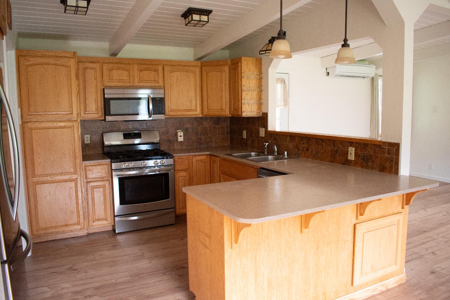 4881 Marshall Road Garden Valley, CA 95633 - Photo 8 of 25 a kitchen with a sink a stove and refrigerator