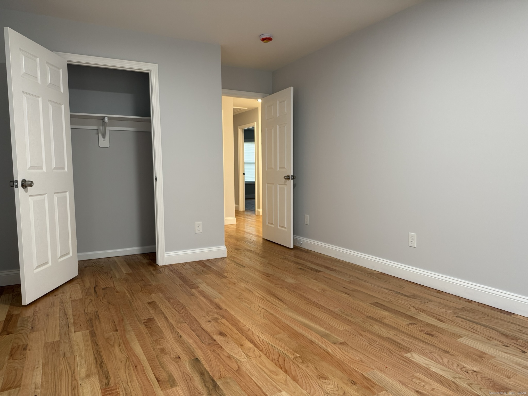 755 Hart Street Bridgeport, CT 06606 - Photo 13 of 37 a view of an empty room with wooden floor and closet