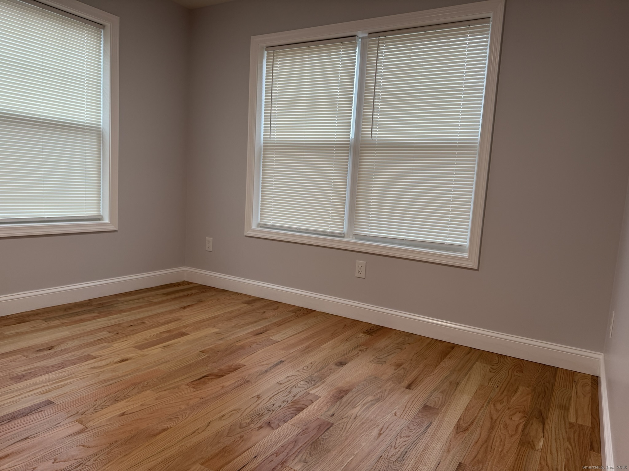 755 Hart Street Bridgeport, CT 06606 - Photo 14 of 37 an empty room with wooden floor and windows